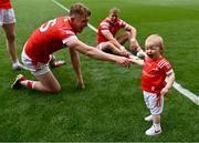 11 May 2025; Izzy Grimes, aged one, daughter of Louth footballer Conor Grimes with Ryan Burns, left, and her father Conor Grimes after the Leinster GAA Football Senior Championship final match between Louth and Meath at Croke Park in Dublin. Photo by Piaras Ó Mídheach/Sportsfile