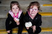 11 May 2025; Sligo supporters Ríadh three years and her sister Saoirse Meehan, 5, from Kesh, Ballymote, enjoys an ice cream before the Táilteann Cup match between Sligo and Tipperary at Kilcoyne Memorial Park in Tubbercurry, Sligo. Photo by Ray McManus/Sportsfile