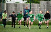 12 May 2025; Olympian Thomas Barr with students from St Laurence's Catholic National School during the Dare to Believe Olympic Schools Programme at St Laurence's Catholic National School in Kildare. Photo by David Fitzgerald/Sportsfile