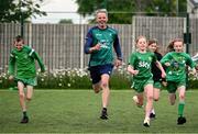 12 May 2025; Olympian Thomas Barr with students from St Laurence's Catholic National School during the Dare to Believe Olympic Schools Programme at St Laurence's Catholic National School in Kildare. Photo by David Fitzgerald/Sportsfile