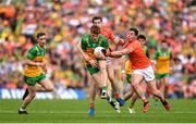 10 May 2025; Ciaran Moore of Donegal in action against Andrew Murnin, left, and Paddy Burns of Armagh during the Ulster GAA Football Senior Championship final match between Armagh and Donegal at St Tiernach's Park in Clones, Monaghan. Photo by Ramsey Cardy/Sportsfile