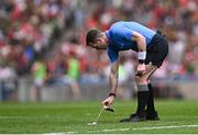 11 May 2025; Referee Martin McNally using vanishing spray to mark the position of a free during the Leinster GAA Football Senior Championship final match between Louth and Meath at Croke Park in Dublin. Photo by Piaras Ó Mídheach/Sportsfile