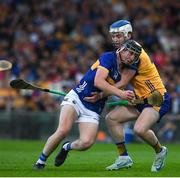 14 May 2025; Paddy McCormack of Tipperary in action against Fiachra Ó Braoin of Clare during the oneills.com Munster GAA Hurling U20 Championship final match between Tipperary and Clare at TUS Gaelic Grounds in Limerick. Photo by John Sheridan/Sportsfile