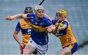 14 May 2025; Oisin O'Donoghue of Tipperary in action against Eoghan Gunning of Clare during the oneills.com Munster GAA Hurling U20 Championship final match between Tipperary and Clare at TUS Gaelic Grounds in Limerick. Photo by Tyler Miller/Sportsfile