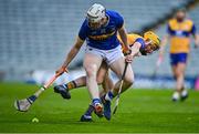 14 May 2025; Oisin O'Donoghue of Tipperary in action against Eoghan Gunning of Clare during the oneills.com Munster GAA Hurling U20 Championship final match between Tipperary and Clare at TUS Gaelic Grounds in Limerick. Photo by Tyler Miller/Sportsfile