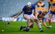 14 May 2025; Oisin O'Donoghue of Tipperary in action against Eoghan Gunning of Clare during the oneills.com Munster GAA Hurling U20 Championship final match between Tipperary and Clare at TUS Gaelic Grounds in Limerick. Photo by Tyler Miller/Sportsfile