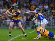 14 May 2025; James Organ of Clare gets a shot off despite the efforts of Jim Ryan during the oneills.com Munster GAA Hurling U20 Championship final match between Tipperary and Clare at TUS Gaelic Grounds in Limerick. Photo by John Sheridan/Sportsfile