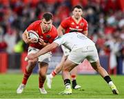 9 May 2025; Tom Farrell of Munster is tackled by Jacob Stockdale of Ulster during the United Rugby Championship match between Munster and Ulster at Thomond Park in Limerick. Photo by Brendan Moran/Sportsfile