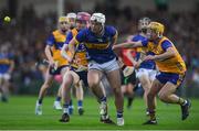 14 May 2025; Darragh McCarthy of Tipperary is tackled by Clare players, from left, John Cahill and Eoghan Gunning during the oneills.com Munster GAA Hurling U20 Championship final match between Tipperary and Clare at TUS Gaelic Grounds in Limerick. Photo by John Sheridan/Sportsfile