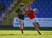 16 May 2025; Conor McCríosta of Louth in action against Oisin Cronin of Mayo during the Dalata Hotel Group GAA Football All-Ireland U20 Championship semi-final match between Mayo and Louth at Glennon Brothers Pearse Park in Longford. Photo by Stephen Marken/Sportsfile