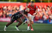 16 May 2025; Diarmuid Kilgallen of Munster is tackled by Tomas Albornoz of Benetton Treviso during the United Rugby Championship match between Munster and Benetton at Virgin Media Park in Cork. Photo by Brendan Moran/Sportsfile