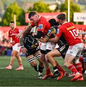 16 May 2025; Peter O'Mahony of Munster is tackled by Jacob Umaga of Benetton Treviso during the United Rugby Championship match between Munster and Benetton at Virgin Media Park in Cork. Photo by Brendan Moran/Sportsfile