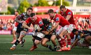 16 May 2025; Peter O'Mahony of Munster is tackled by Jacob Umaga of Benetton Treviso during the United Rugby Championship match between Munster and Benetton at Virgin Media Park in Cork. Photo by Brendan Moran/Sportsfile