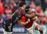 16 May 2025; Thaakir Abrahams of Munster is tackled by Tommaso Menoncello of Benetton Treviso during the United Rugby Championship match between Munster and Benetton at Virgin Media Park in Cork. Photo by Brendan Moran/Sportsfile