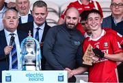 16 May 2025; Tom A Walsh of Cork receives the Electric Ireland Player of The Match Award from Paddy Hasset of Electric Ireland following his performance in the Electric Ireland GAA Hurling Munster Minor Championship final match between Cork and Waterford at FBD Semple Stadium in Thurles, Tipperary. Photo by Piaras Ó Mídheach/Sportsfile