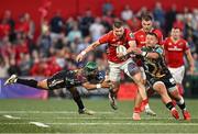 16 May 2025; Diarmuid Kilgallen of Munster is tackled by Rhyno Smith of Benetton Treviso during the United Rugby Championship match between Munster and Benetton at Virgin Media Park in Cork. Photo by Brendan Moran/Sportsfile