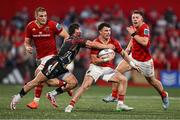 16 May 2025; Calvin Nash of Munster is tackled by Alessandro Garbisi of Benetton Treviso during the United Rugby Championship match between Munster and Benetton at Virgin Media Park in Cork. Photo by Brendan Moran/Sportsfile