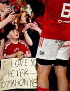 16 May 2025; Munster supporter Tadhg Daly, from Dungarvan in Waterford, watches as Peter O'Mahony of Munster signs autographs after the United Rugby Championship match between Munster and Benetton at Virgin Media Park in Cork. Photo by Brendan Moran/Sportsfile