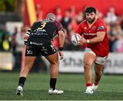 16 May 2025; Michael Milne of Munster in action against Simone Ferrari of Benetton Treviso during the United Rugby Championship match between Munster and Benetton at Virgin Media Park in Cork. Photo by Brendan Moran/Sportsfile