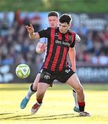 16 May 2025; James Clarke of Bohemians in action against Kameron Ledwidge of Shelbourne during the SSE Airtricity Men's Premier Division match between Bohemians and Shelbourne at Dalymount Park in Dublin. Photo by Seb Daly/Sportsfile