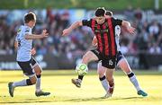 16 May 2025; James Clarke of Bohemians in action against James Norris, left, and Kameron Ledwidge of Shelbourne during the SSE Airtricity Men's Premier Division match between Bohemians and Shelbourne at Dalymount Park in Dublin. Photo by Seb Daly/Sportsfile