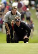 17 September 2004; Lee Westwood gives Darren Clarke a hand to line up his putt on the 11th green during the Friday afternoon foursomes. 35th Ryder Cup Matches, Oakland Hills Country Club, Bloomfield Township, Michigan, USA. Picture credit; Matt Browne / SPORTSFILE