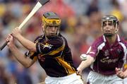 12 September 2004; Liam Tierney, Kilkenny, in action against Kerril Wade, Galway. All-Ireland Minor Hurling Championship Final, Galway v Kilkenny, Croke Park, Dublin. Picture credit; Brendan Moran / SPORTSFILE *** Local Caption *** Any photograph taken by SPORTSFILE during, or in connection with, the 2004 Guinness All-Ireland Hurling Final which displays GAA logos or contains an image or part of an image of any GAA intellectual property, or, which contains images of a GAA player/players in their playing uniforms, may only be used for editorial and non-advertising purposes.  Use of photographs for advertising, as posters or for purchase separately is strictly prohibited unless prior written approval has been obtained from the Gaelic Athletic Association.