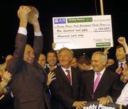 18 September 2004; Winning owner Michael Kelly celebrates after receiving the trophy from an Taoiseach Bertie Ahern, T.D., after Like A Shot had won the Paddy Power Irish Greyhound Derby, Shelbourne Park, Dublin. Picture credit; Pat Murphy / SPORTSFILE