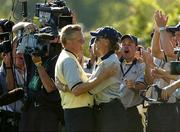 19 September 2004; Colin Montgomerie is congratulated by captain Bernhard Langer, right, on the 18th green after Europe had won the Ryder Cup. 35th Ryder Cup Matches, Oakland Hills Country Club, Bloomfield Township, Michigan, USA. Picture credit; Matt Browne / SPORTSFILE