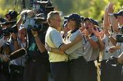 19 September 2004; Colin Montgomerie is congratulated by captain Bernhard Langer, right, on the 18th green after Europe had won the Ryder Cup. 35th Ryder Cup Matches, Oakland Hills Country Club, Bloomfield Township, Michigan, USA. Picture credit; Matt Browne / SPORTSFILE