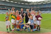 11 October 2013; Former GAA President Sean Kelly MEP, right, presents Uachtarán Chumann Lúthchleas Gael Liam Ó Néill with the European Citizen's medal, in the company of children from the Holy Trinity School, Donaghmede, from left, Robert O'Connor, Amy Redmond, Tmoni Nolan, Aaron O'Mahony, Dylan Fowler, Gemma Keenan, Megan Kennedy, Gavin Donegan, Sarah Keenan, Hollyjo Clarke, Jasmine Kamtoh and John O'Reilly, after the Gaelic Athletic Association was announced as winner of the European Citizen's Prize 2013. Croke Park, Dublin. Picture credit: Matt Browne / SPORTSFILE
