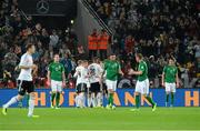 11 October 2013; Germany players celebrate after Sami Khedira scored their side's first goal as Republic of Ireland players, from left to right, Anthony Stokes, Damien Delaney, James McCarthy and Stephen Kelly look on dejected. 2014 FIFA World Cup Qualifier, Group C, Germany v Republic of Ireland, Rhine Energie Stadion, Cologne, Germany.  Picture credit: David Maher / SPORTSFILE