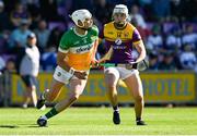 17 May 2025; Ross Ravenhill of Offaly in action against Rory O'Connor of Wexford during the Leinster GAA Hurling Senior Championship Round 4 match between Wexford and Offaly at Chadwicks Wexford Park in Wexford. Photo by Matt Browne/Sportsfile