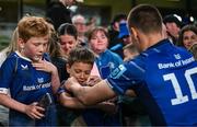 17 May 2025; Leinster supporter Noah Harry has his jersey signed by Sam Prendergast of Leinster after the United Rugby Championship match between Leinster and Glasgow Warriors at the Aviva Stadium in Dublin. Photo by Ramsey Cardy/Sportsfile