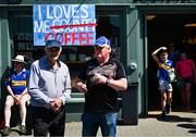 18 May 2025; Tipperary supporters Liam Ryan, left, and John Collins stand outside of a local coffee shop before the Munster GAA Hurling Senior Championship Round 4 match between Tipperary and Waterford at FBD Semple Stadium in Thurles, Tipperary. Photo by Tyler Miller/Sportsfile