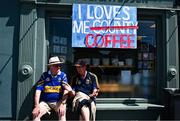 18 May 2025; Tipperary supporters and brothers Tony Marshall, left, and Michael Marshall sit outside a local coffee shop before the Munster GAA Hurling Senior Championship Round 4 match between Tipperary and Waterford at FBD Semple Stadium in Thurles, Tipperary. Photo by Tyler Miller/Sportsfile