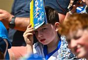 18 May 2025; A young supporter uses a matchday programme to block the sun during the Munster GAA Hurling Senior Championship Round 4 match between Tipperary and Waterford at FBD Semple Stadium in Thurles, Tipperary. Photo by Tyler Miller/Sportsfile