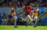 18 May 2025; Odhran Murdock of Down in action against Eoin Cleary, left, and Cillian Rouine of Clare during the GAA Football All-Ireland Senior Championship Round 1 match between Clare and Down at Zimmer Biomet Páirc Chíosóg in Ennis, Clare. Photo by Tom Beary/Sportsfile