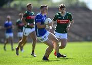 18 May 2025; Cormac O'Reilly of Cavan gets away from Sam Callinan of Mayo during the GAA Football All-Ireland Senior Championship Round 1 match between Mayo and Cavan at Hastings Insurance MacHale Park in Castlebar, Mayo. Photo by Piaras Ó Mídheach/Sportsfile
