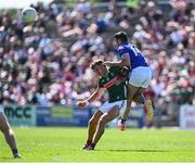 18 May 2025; Jordan Flynn of Mayo is tackled after passing the ball by Ryan Donohoe of Cavan during the GAA Football All-Ireland Senior Championship Round 1 match between Mayo and Cavan at Hastings Insurance MacHale Park in Castlebar, Mayo. Photo by Piaras Ó Mídheach/Sportsfile