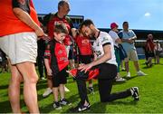 18 May 2025; Down manager Conor Laverty signs his autograph on the flag of a young Down supporter after the GAA Football All-Ireland Senior Championship Round 1 match between Clare and Down at Zimmer Biomet Páirc Chíosóg in Ennis, Clare. Photo by Tom Beary/Sportsfile