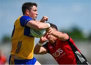 18 May 2025; Keelan Sexton of Clare is tackled by Pierce Laverty of Down during the GAA Football All-Ireland Senior Championship Round 1 match between Clare and Down at Zimmer Biomet Páirc Chíosóg in Ennis, Clare. Photo by Tom Beary/Sportsfile