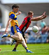 18 May 2025; Jamie Stack of Clare scores a point despite the attention of Caolan Mooney of Down during the GAA Football All-Ireland Senior Championship Round 1 match between Clare and Down at Zimmer Biomet Páirc Chíosóg in Ennis, Clare. Photo by Tom Beary/Sportsfile