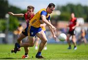 18 May 2025; Mark McInerney of Clare is tackled by Ryan Magill of Down during the GAA Football All-Ireland Senior Championship Round 1 match between Clare and Down at Zimmer Biomet Páirc Chíosóg in Ennis, Clare. Photo by Tom Beary/Sportsfile