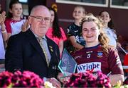 18 May 2025; Sarah Murphy of Westmeath receives the Player of the Match award from Arthur Corrigan, Leinster LGFA President, after the TG4 Leinster LGFA Intermediate Championship final match between Laois and Westmeath at TEG Cusack Park in Mullingar, Westmeath. Photo by Seb Daly/Sportsfile