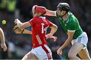 18 May 2025; Alan Connolly of Cork has his helmet grabbed by Diarmaid Byrnes of Limerick during the Munster GAA Hurling Senior Championship Round 4 match between Limerick and Cork at TUS Gaelic Grounds in Limerick. Photo by Brendan Moran/Sportsfile