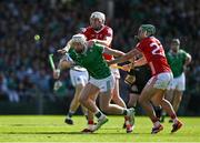 18 May 2025; Cian Lynch of Limerick is tackled by Tim O'Mahony and /c22 during the Munster GAA Hurling Senior Championship Round 4 match between Limerick and Cork at TUS Gaelic Grounds in Limerick. Photo by Brendan Moran/Sportsfile