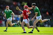 18 May 2025; Alan Connolly of Cork is tackled by Diarmaid Byrnes of Limerick during the Munster GAA Hurling Senior Championship Round 4 match between Limerick and Cork at TUS Gaelic Grounds in Limerick. Photo by Brendan Moran/Sportsfile