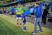 17 May 2025; Mascot Harry Dunne with Josh van der Flier before the United Rugby Championship match between Leinster and Glasgow Warriors at the Aviva Stadium in Dublin. Photo by Ramsey Cardy/Sportsfile