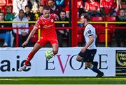19 May 2025; Evan Caffrey of Shelbourne in action against Andrew Quinn of Drogheda United during the SSE Airtricity Men's Premier Division match between Shelbourne and Drogheda United at Tolka Park in Dublin. Photo by Tyler Miller/Sportsfile